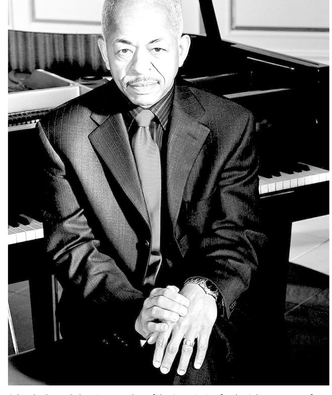 Adegoke Steve Colson seated at a piano, black and white photograph from the Chicago Tribune, 2021